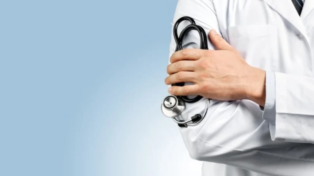 Healthcare professional in a white coat holding a stethoscope